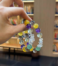 Handheld mixed gemstone bracelet showing approximately 0.47 inch or 12 mm bead scale and varied stone shapes