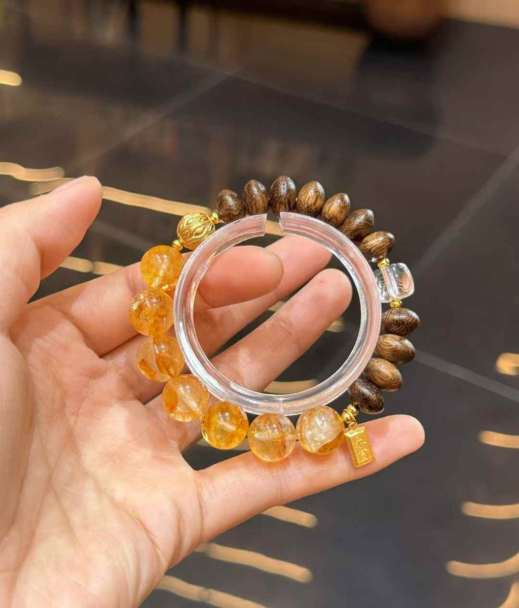 Detailed bracelet view showing Agarwood beads, Clear Quartz and gold-plated copper decorative components