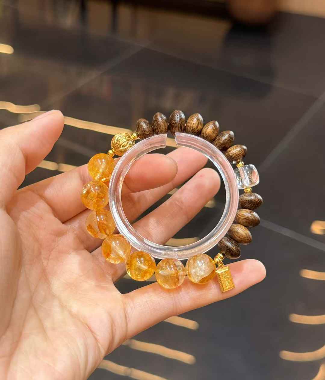 Detailed bracelet view showing Agarwood beads, Clear Quartz and gold-plated copper decorative components