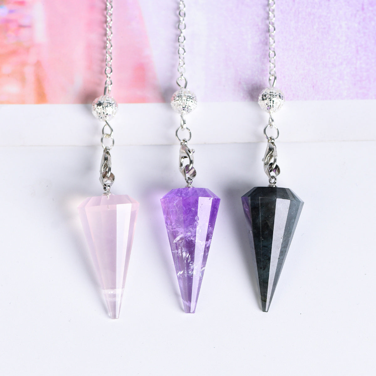 Amethyst 12-facet pointed crystal pendulum with silver-tone link chain and decorative end bead