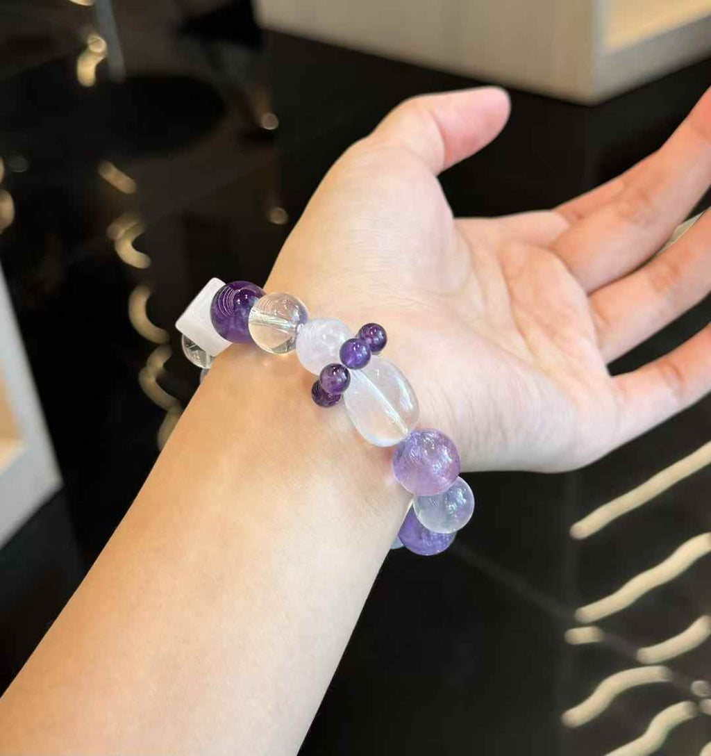 Close-up of deep purple Amethyst and soft Lavender Amethyst beads with polished translucent surfaces