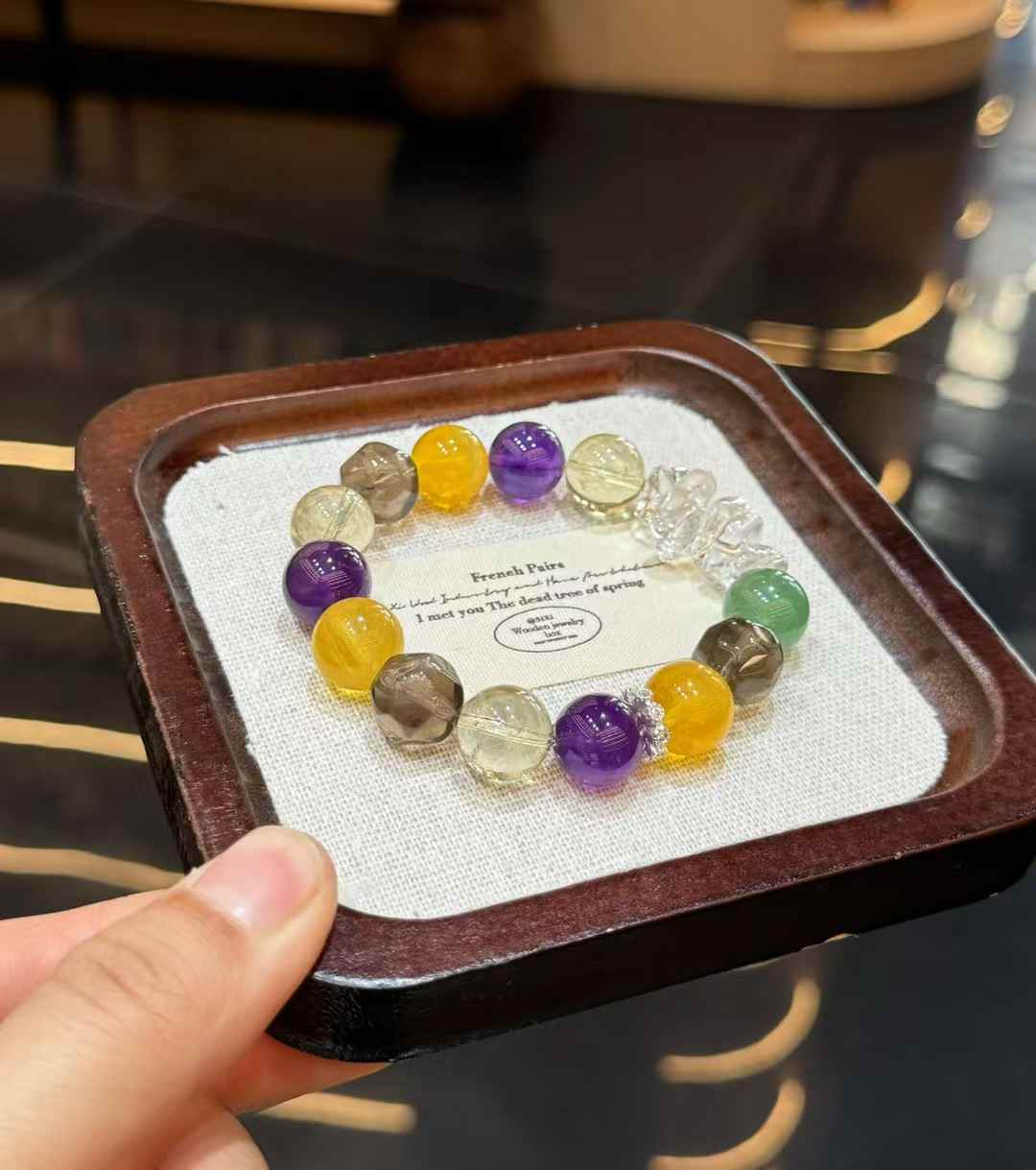 Full view of autumn-inspired mixed crystal bracelet with purple, yellow, green, smoky and clear gemstone beads