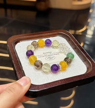 Full view of autumn-inspired mixed crystal bracelet with purple, yellow, green, smoky and clear gemstone beads