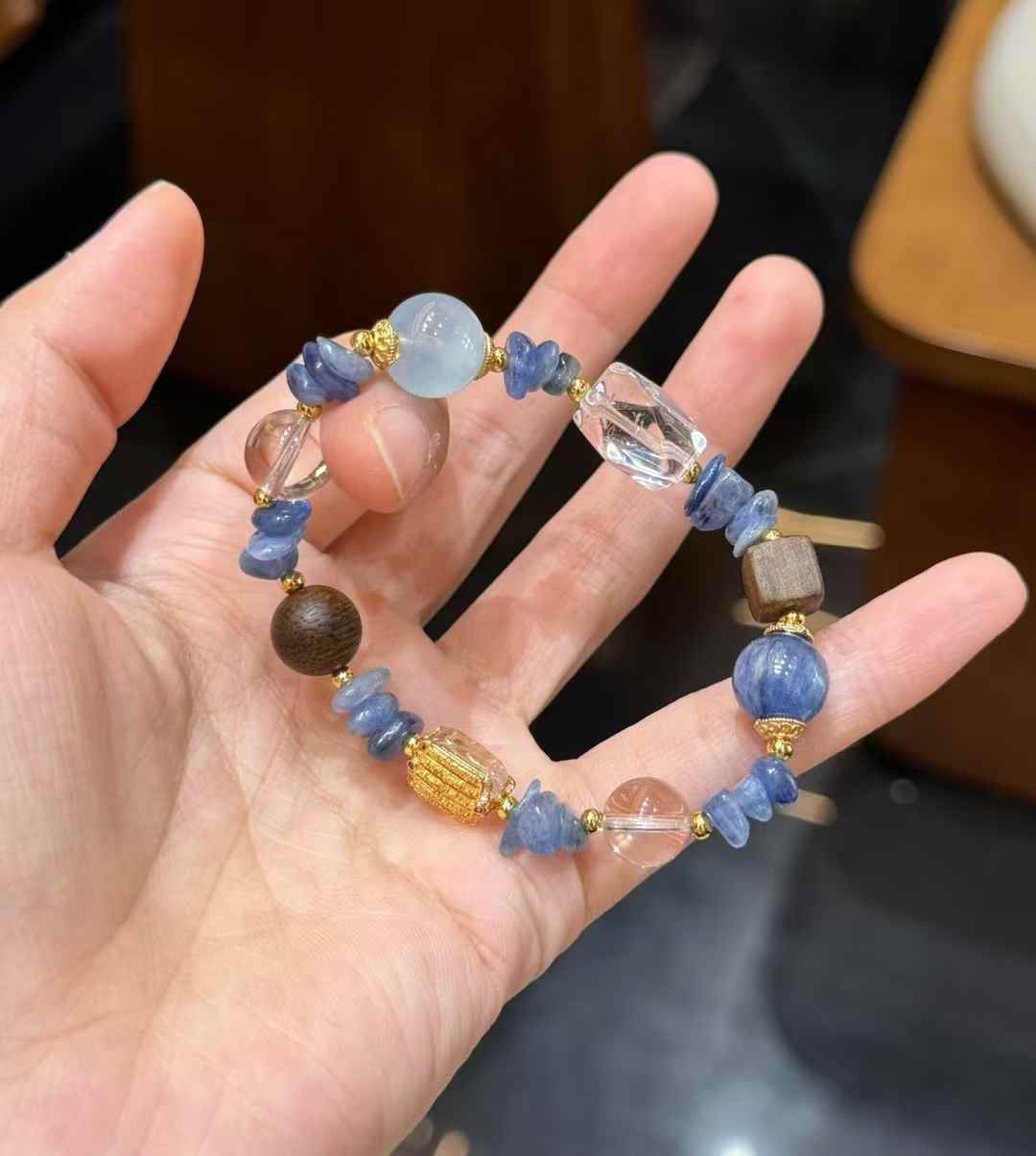 Full view of the bracelet showing blue crystal chips, round Aquamarine beads, Clear Quartz beads and mixed textures