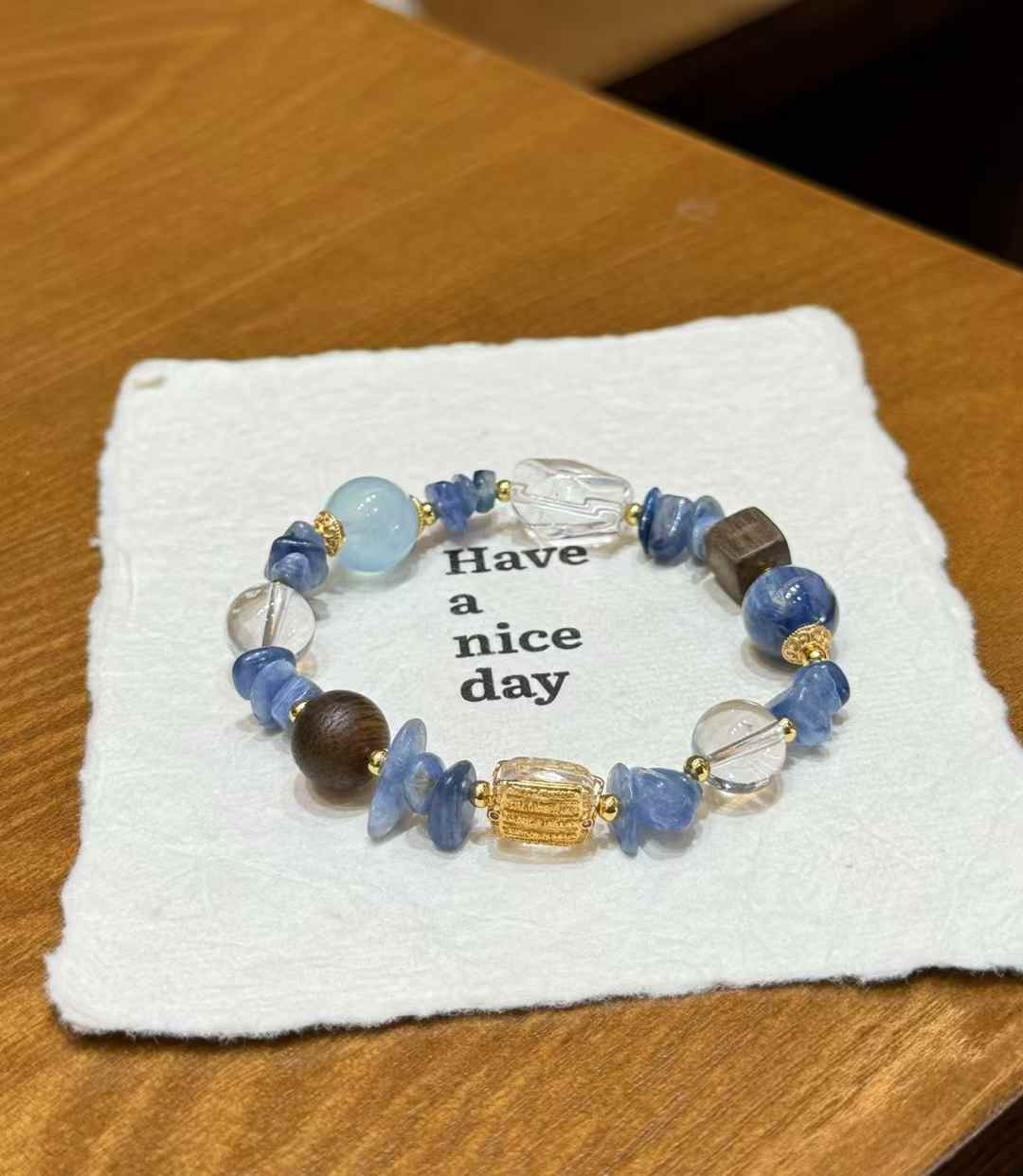 Flat lay of the ocean-inspired gemstone bracelet styled on white fabric with a clean minimal presentation