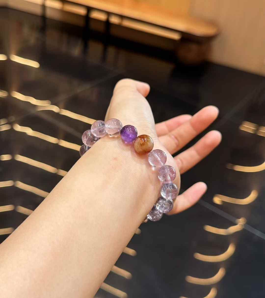 Bolivian Amethyst and Kunzite bracelet worn on the wrist with soft translucent purple tones