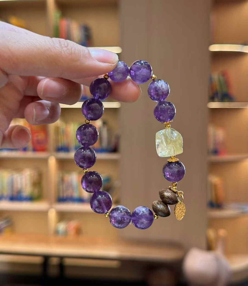 Detail view of the freeform Brazilian Citrine centerpiece, Agarwood beads and gold-tone dangling charm
