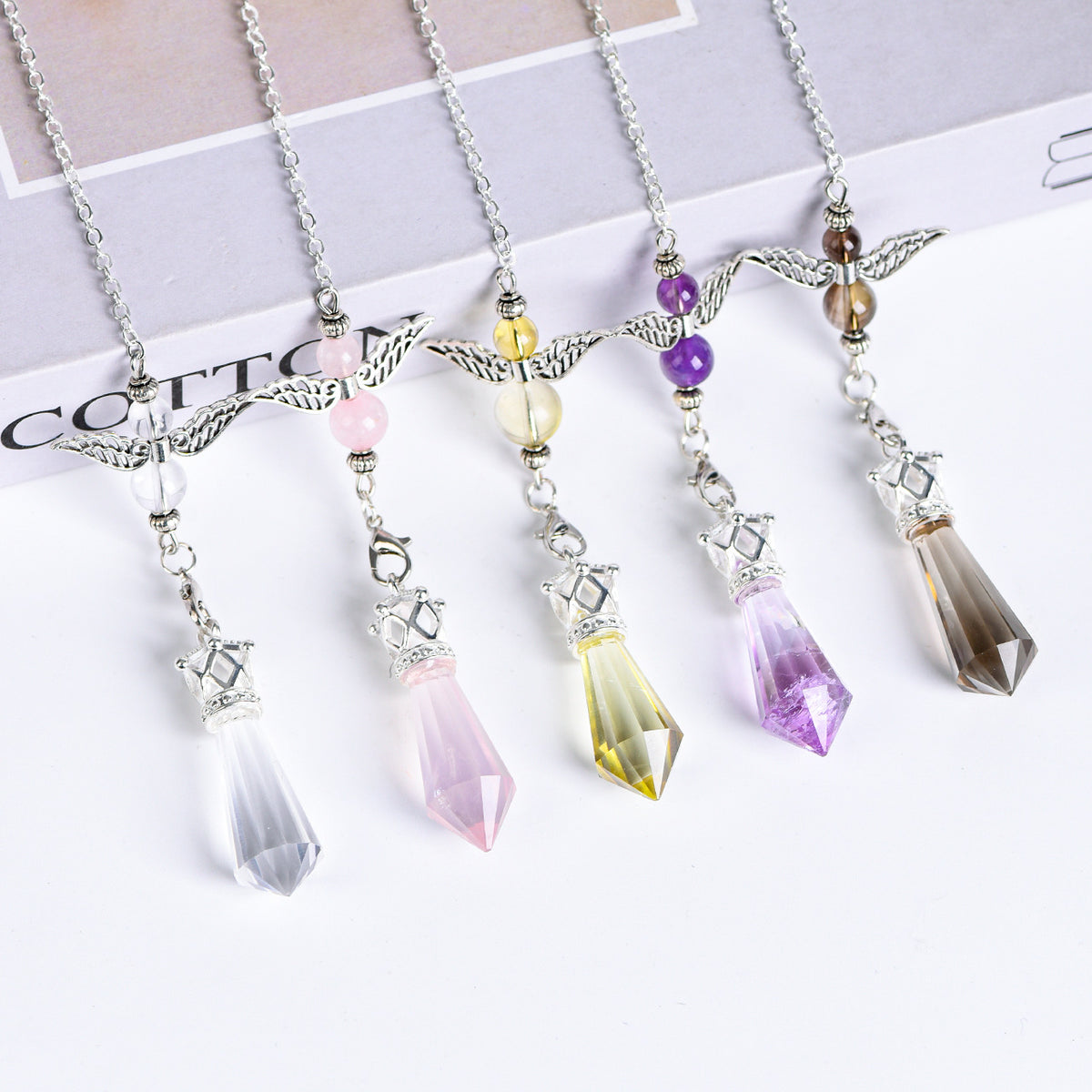 Citrine angel-wing crystal pendulum with faceted point, silver-tone chain and decorative beads