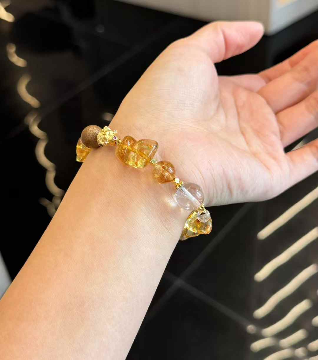Detail view of gold-plated copper accessories between Brazilian Citrine, Clear Quartz and Agarwood beads
