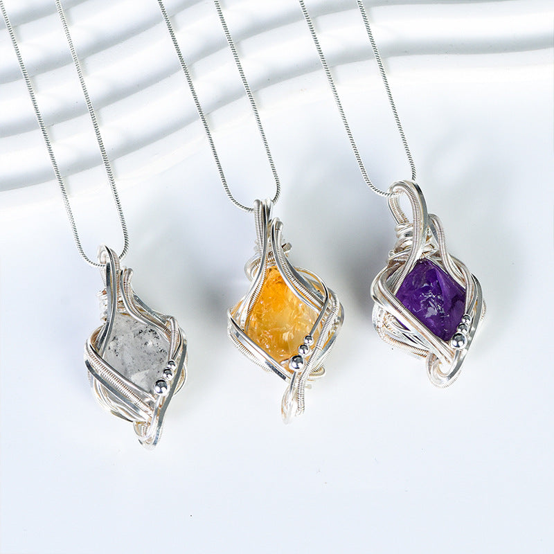 Citrine freeform crystal pendant framed in flowing silver-tone wire with matching necklace chain