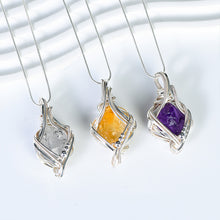 Citrine freeform crystal pendant framed in flowing silver-tone wire with matching necklace chain