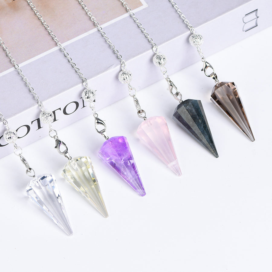 Clear Quartz 12-facet pointed crystal pendulum with silver-tone chain on a white background