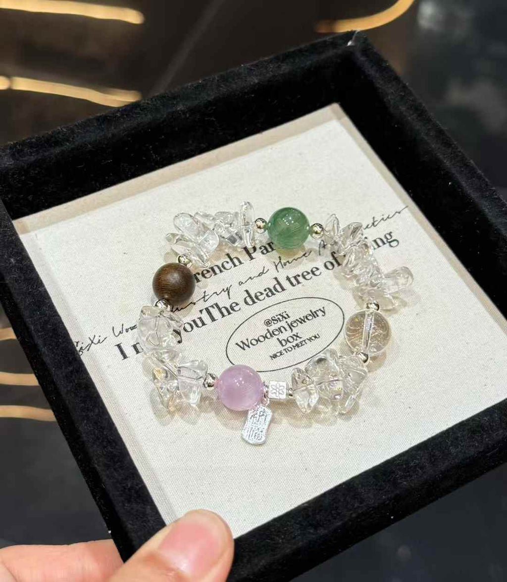 Full view of Clear Quartz chip bracelet with green gemstone, lavender Kunzite bead and Agarwood accent