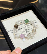 Full view of Clear Quartz chip bracelet with green gemstone, lavender Kunzite bead and Agarwood accent