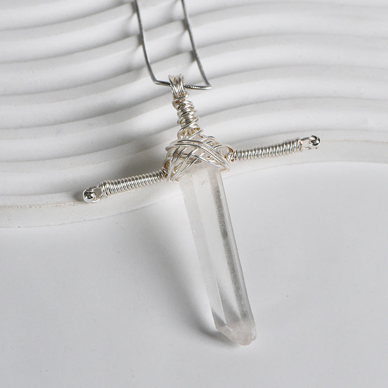 Full view of a polished Clear Quartz sword-inspired pendant with silver-tone wire wrapping and chain
