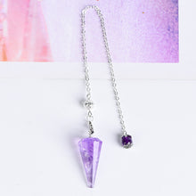 Close-up of the silver-tone chain, connecting clasp and faceted crystal pendulum hardware
