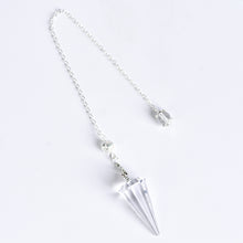 12-facet crystal pendulum displayed beside everyday objects to show its compact scale