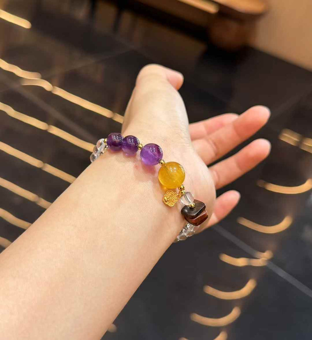 Double-strand crystal bracelet worn on the wrist with Amethyst, Yellow Fluorite and Agarwood focal details
