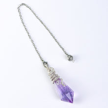 Full crystal pendulum and chain shown on a white surface to illustrate the overall scale and proportions