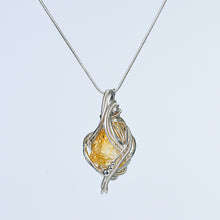 Freeform wire-wrapped crystal pendant necklace worn at the neckline to show its statement scale