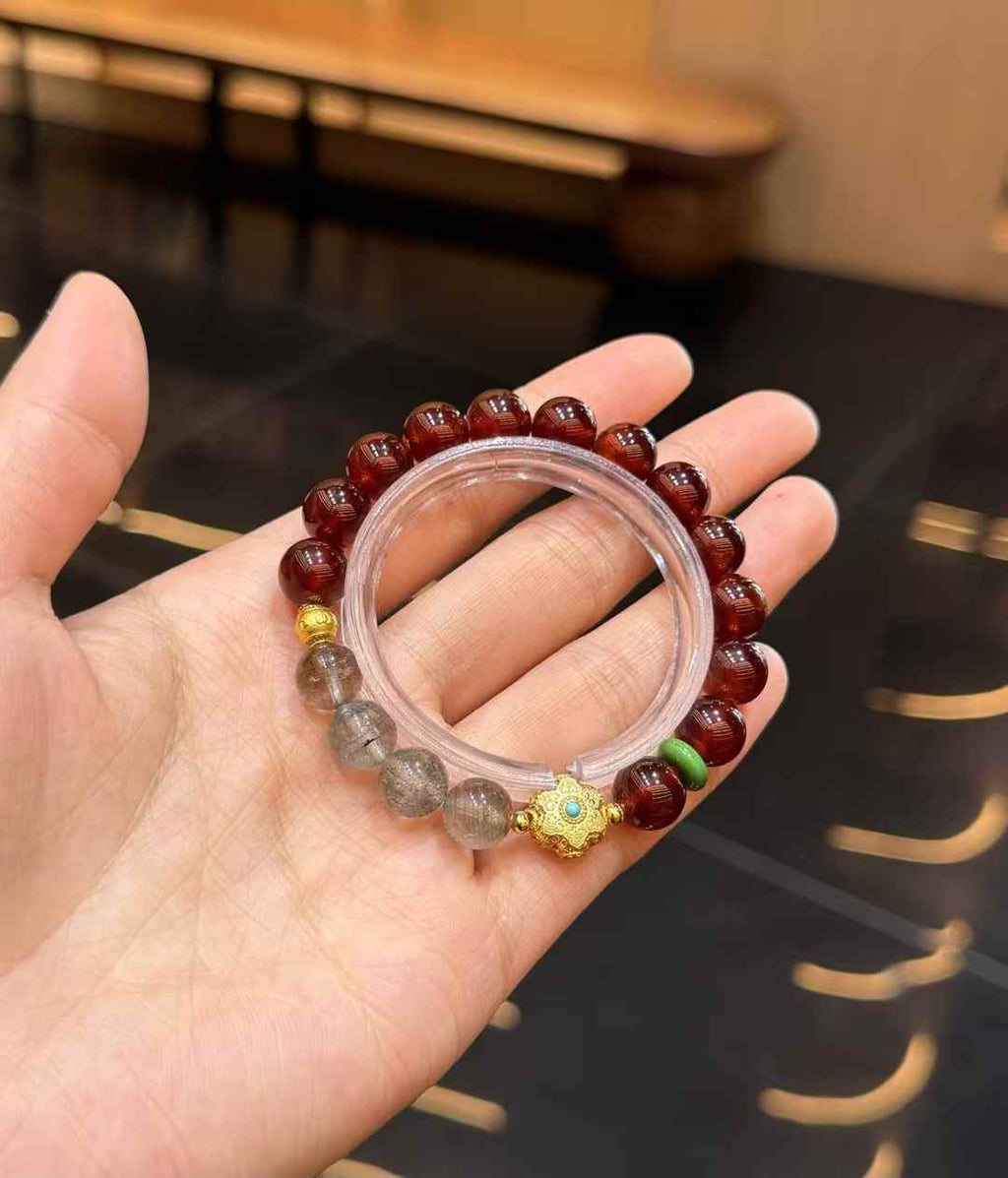 Style comparison view highlighting the contrast between burgundy Garnet and layered Green Phantom Quartz beads