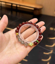 Style comparison view highlighting the contrast between burgundy Garnet and layered Green Phantom Quartz beads