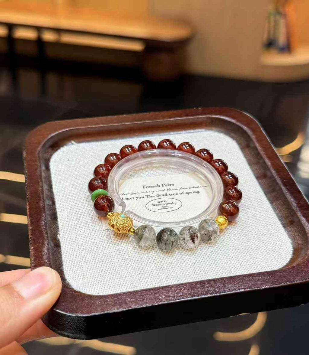 Veridia Garnet and Green Phantom Quartz beaded bracelet displayed on a neutral jewelry tray