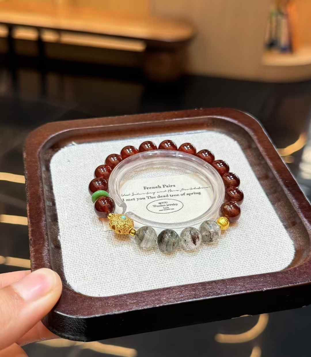 Veridia Garnet and Green Phantom Quartz beaded bracelet displayed on a neutral jewelry tray