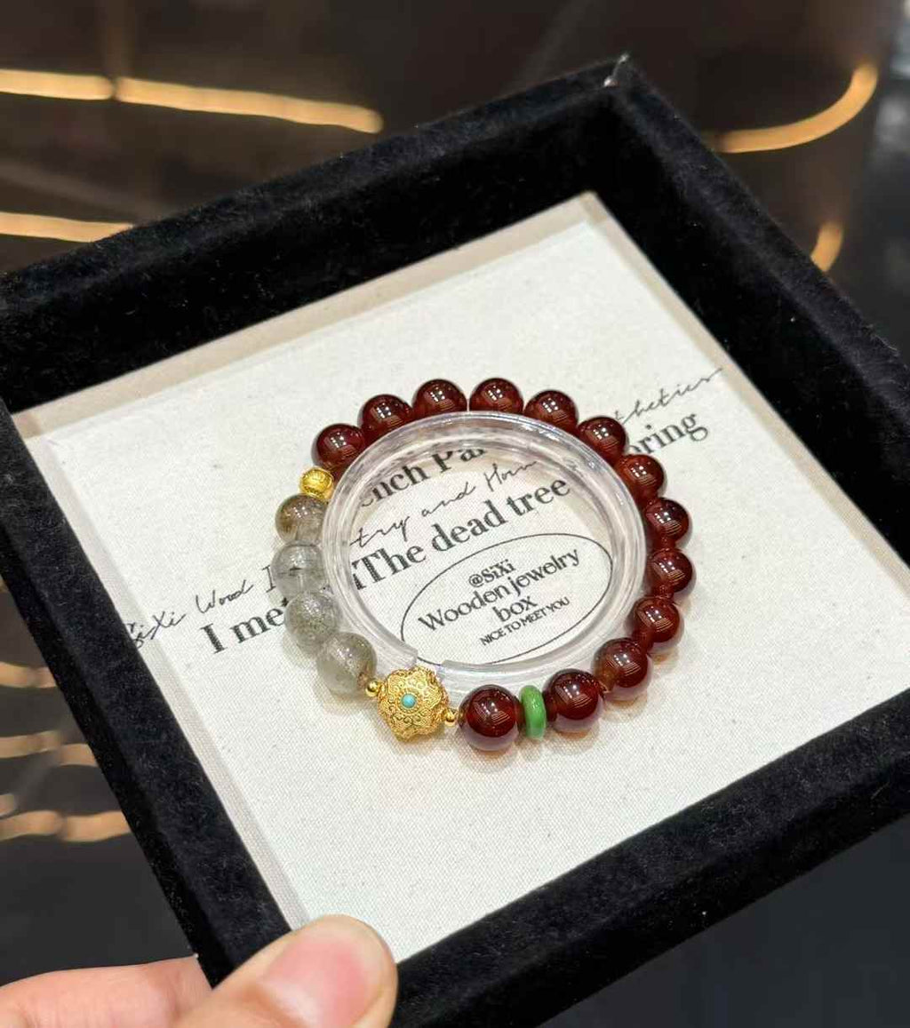 Full view of the Garnet and Green Phantom Quartz bracelet with gold-tone focal detail and green accent spacer