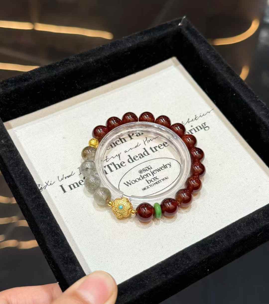 Full view of the Garnet and Green Phantom Quartz bracelet with gold-tone focal detail and green accent spacer