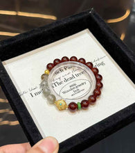 Full view of the Garnet and Green Phantom Quartz bracelet with gold-tone focal detail and green accent spacer
