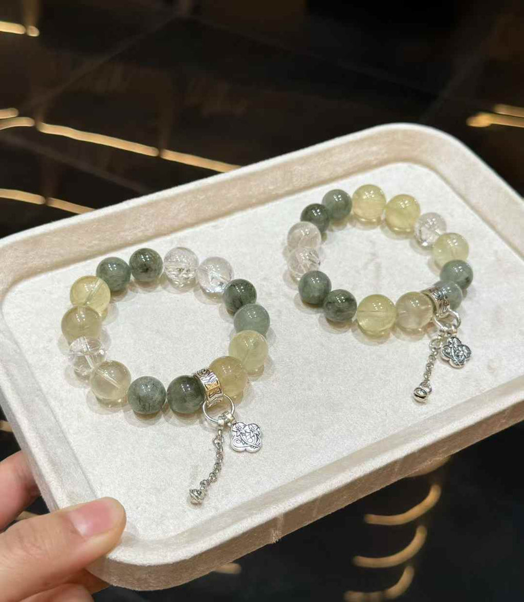 Veridia Green Rutilated Quartz and Lemon Quartz bracelet worn on the wrist with silver-tone dangling charm details
