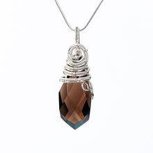 Handmade natural crystal pendant necklace arranged in a clean jewelry gift display