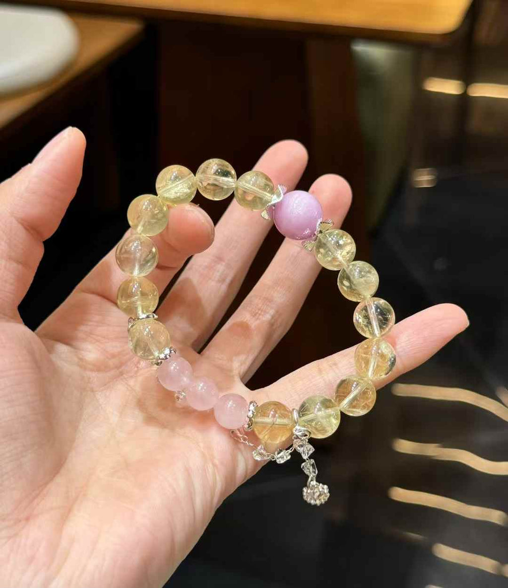 Close-up detail of translucent Lemon Quartz beads with soft yellow tones and polished round surfaces