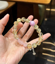 Close-up detail of translucent Lemon Quartz beads with soft yellow tones and polished round surfaces