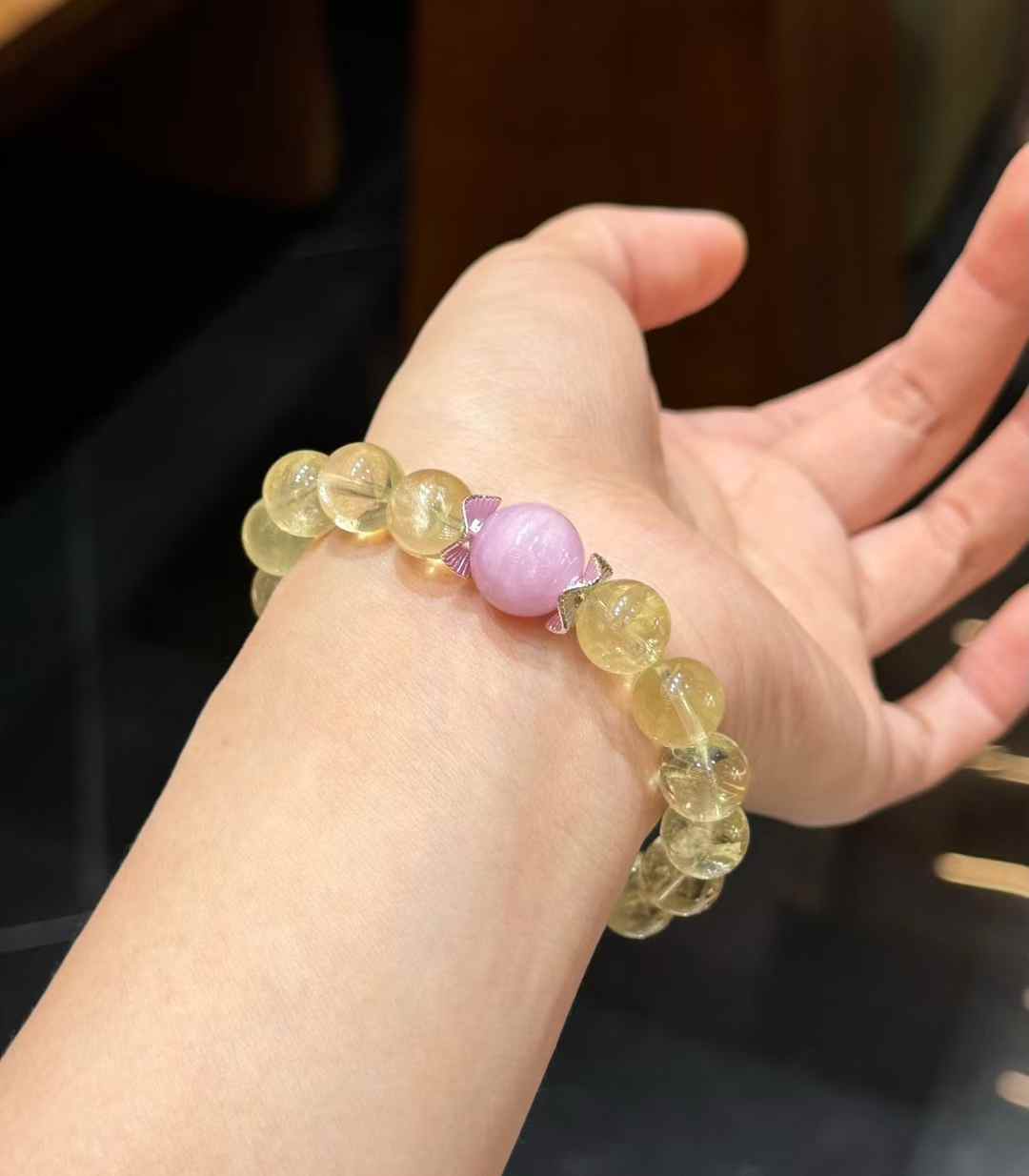 Multiple bracelets shown together to compare the dangle charm style and pastel crystal arrangement