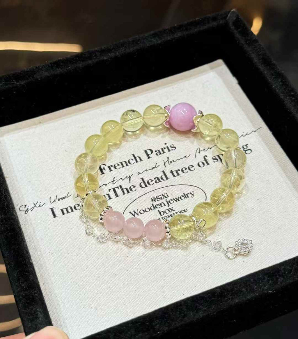 Full view of the bracelet showing pale yellow Lemon Quartz beads, a lavender Kunzite focal bead and soft pink Rose Quartz accents