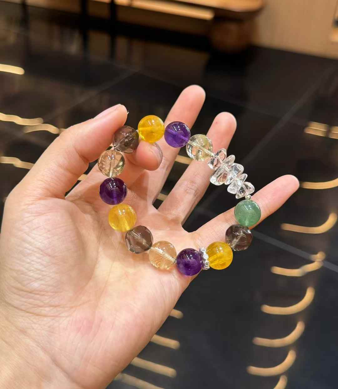 Mixed gemstone bracelet showing irregular Clear Quartz accents among polished multicolor crystal beads