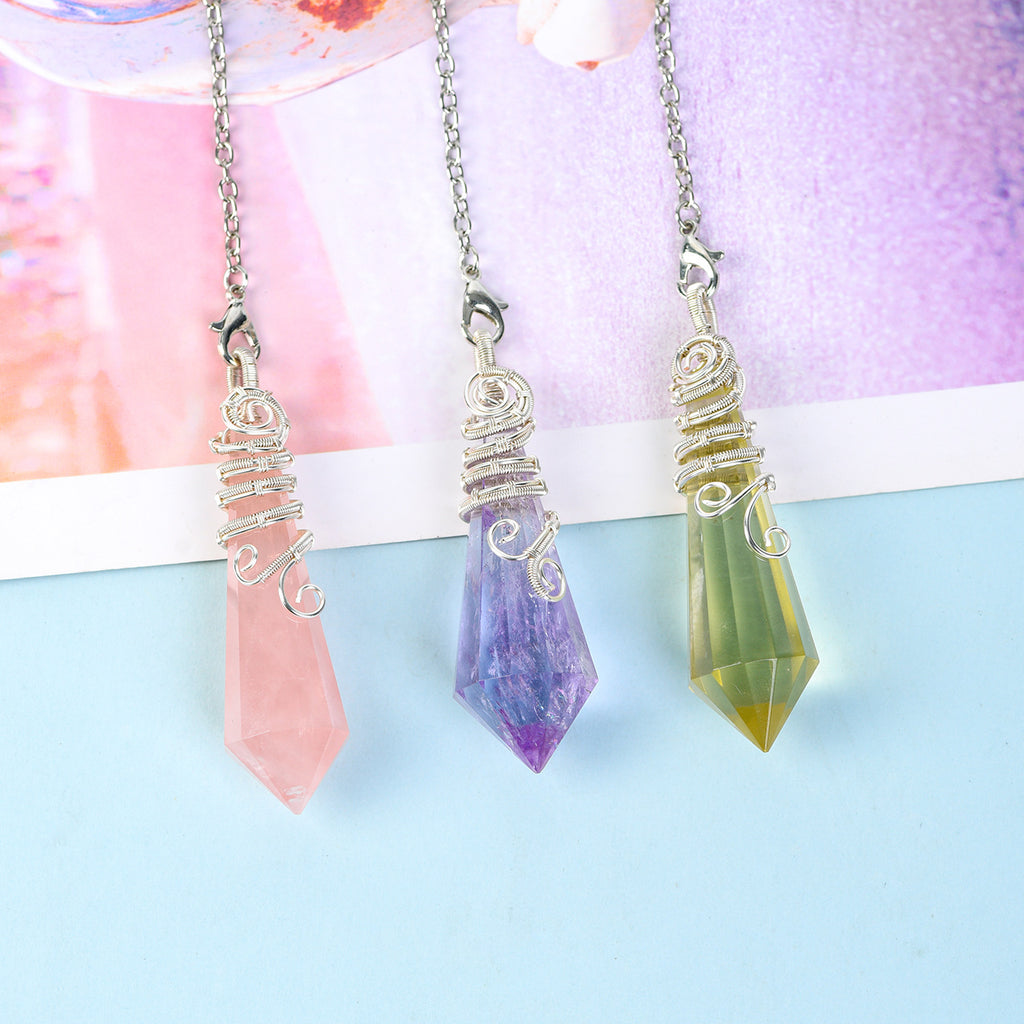 Full view of a natural crystal pendulum with silver-tone chain, clasp and decorative wire-wrapped point