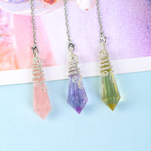 Full view of a natural crystal pendulum with silver-tone chain, clasp and decorative wire-wrapped point
