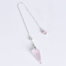 Natural crystal pendulum arranged in a clean jewelry and spiritual gift display