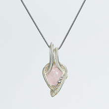 Freeform crystal pendant highlighting its organic stone shape and flowing sculptural wire-wrapped design