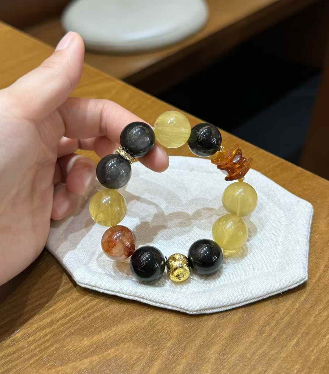 Oversized gemstone stretch bracelet held in hand showing the scale of approximately 0.63 inch round beads