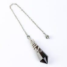Pointed 12-facet crystal pendulum highlighting its directional geometric shape and decorative wire-wrapped design
