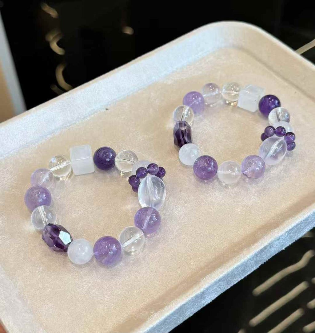 Two matching purple mixed-crystal bracelets displayed together for style and bead arrangement comparison