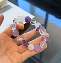 Full view of the purple and clear crystal bracelet showing round, faceted, cube and oval bead shapes