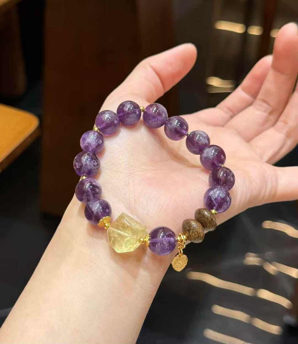 Close-up of polished Purple Rabbit Hair Quartz beads showing rich violet tones and visible internal crystal texture