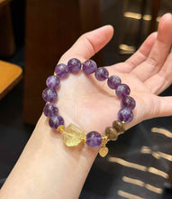 Close-up of polished Purple Rabbit Hair Quartz beads showing rich violet tones and visible internal crystal texture