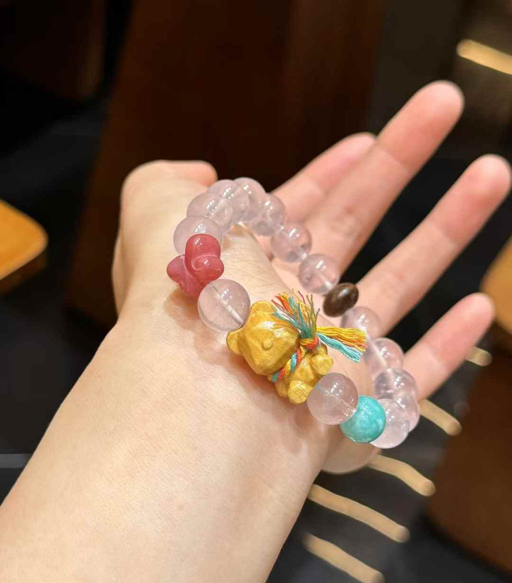 Rose Quartz bear charm bracelet worn on the wrist showing the bracelet scale and playful summer design