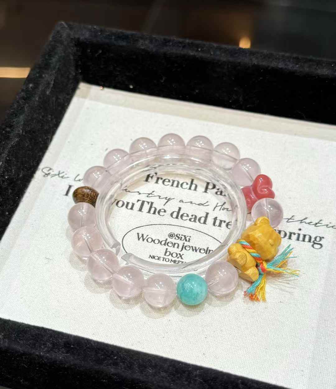 Veridia Rose Quartz bead bracelet with Bodhi butterfly accent, wooden bear charm and colorful decorative beads